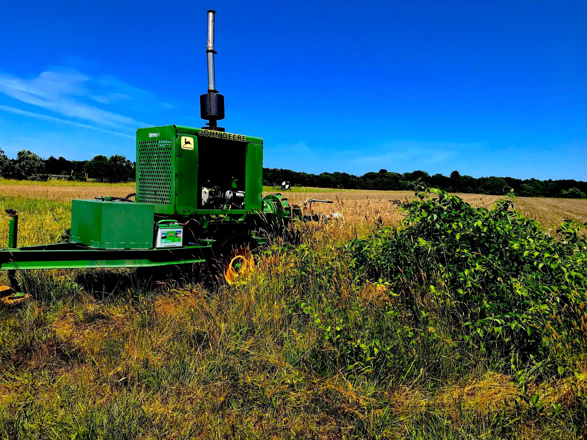 John Deer next to a field that you pass on the right of the grassy trail.