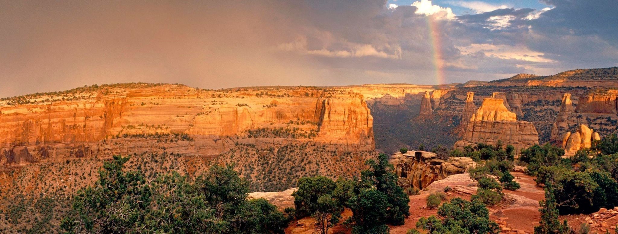Rainbow over the rocky sandstone cliffs at Colorado National Monument.