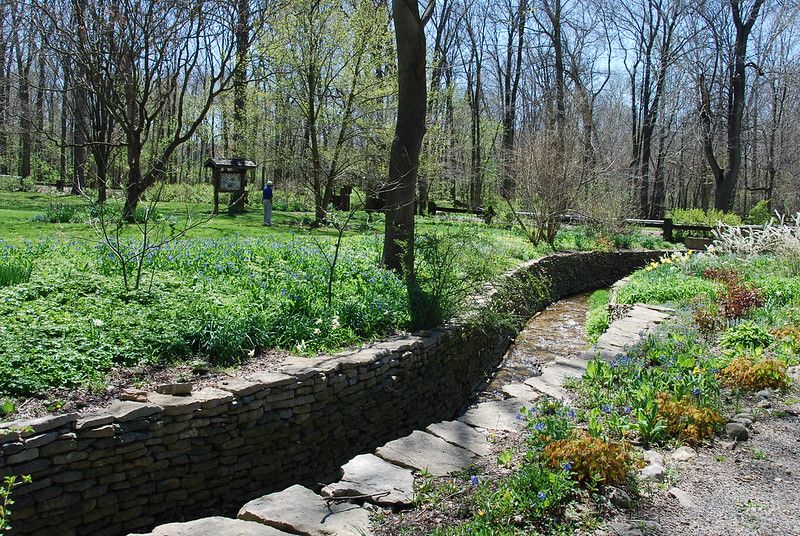 The stone walls that line Wiles Creek were built in the 	1930’S. This area features newly constructed dry laid stone walls that will help preserve the 	garden beds from erosion. 