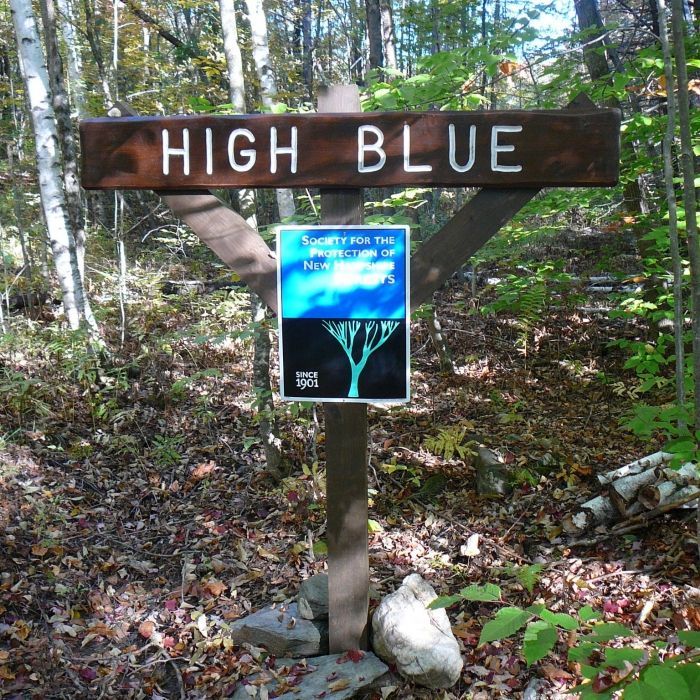 A sign for High Blue in the forest.