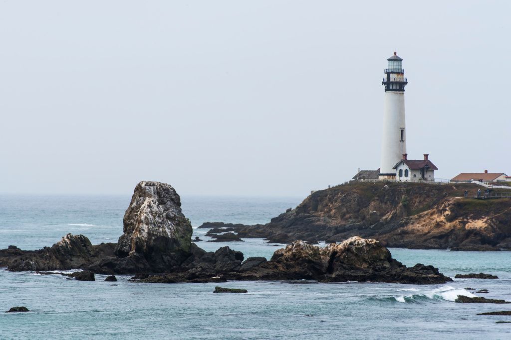 Pigeon Point Lighthouse and coastal rock outcrops.
