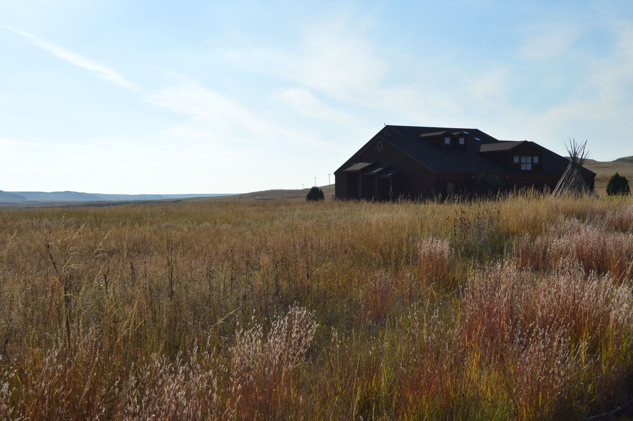 From the Fossil Hills Trail the Visitor Center is a ship in a sea of prairie grasses.