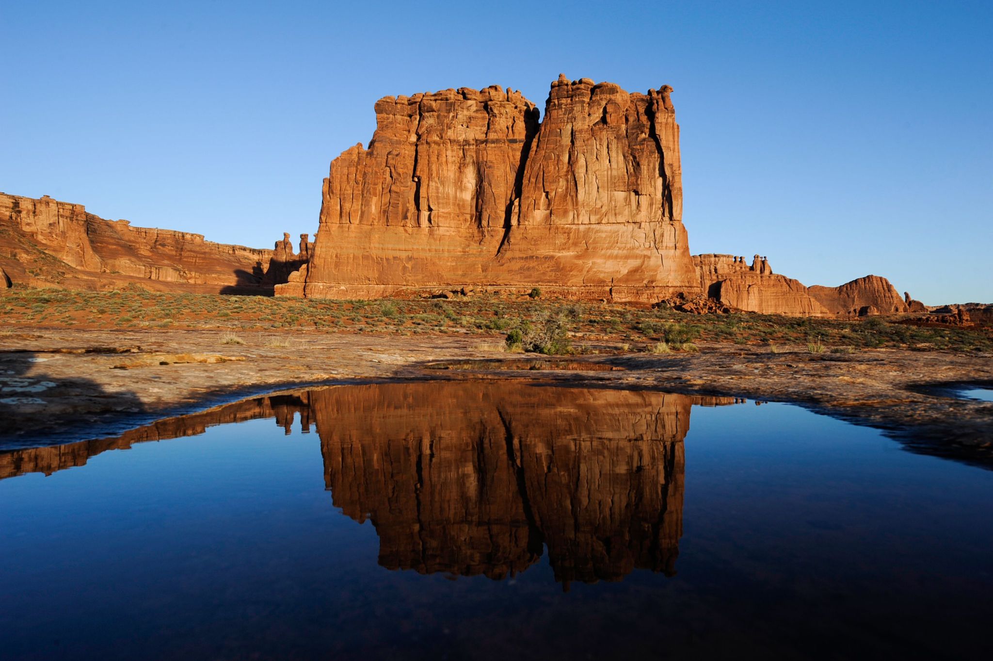 The Organ rock formation is reflected in one of many natural potholes.