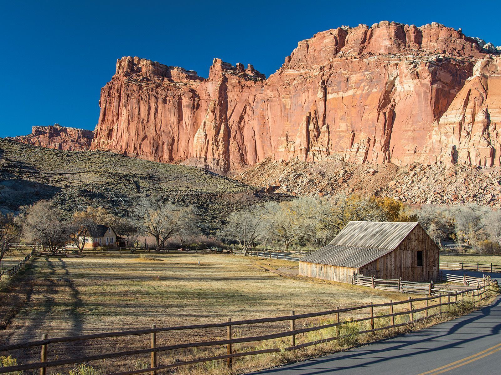 Windgate sandstone towers above historic Fruita farms and homes