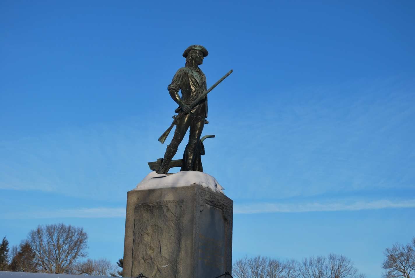 The embattled farmer stands guard over North Bridge, Concord.