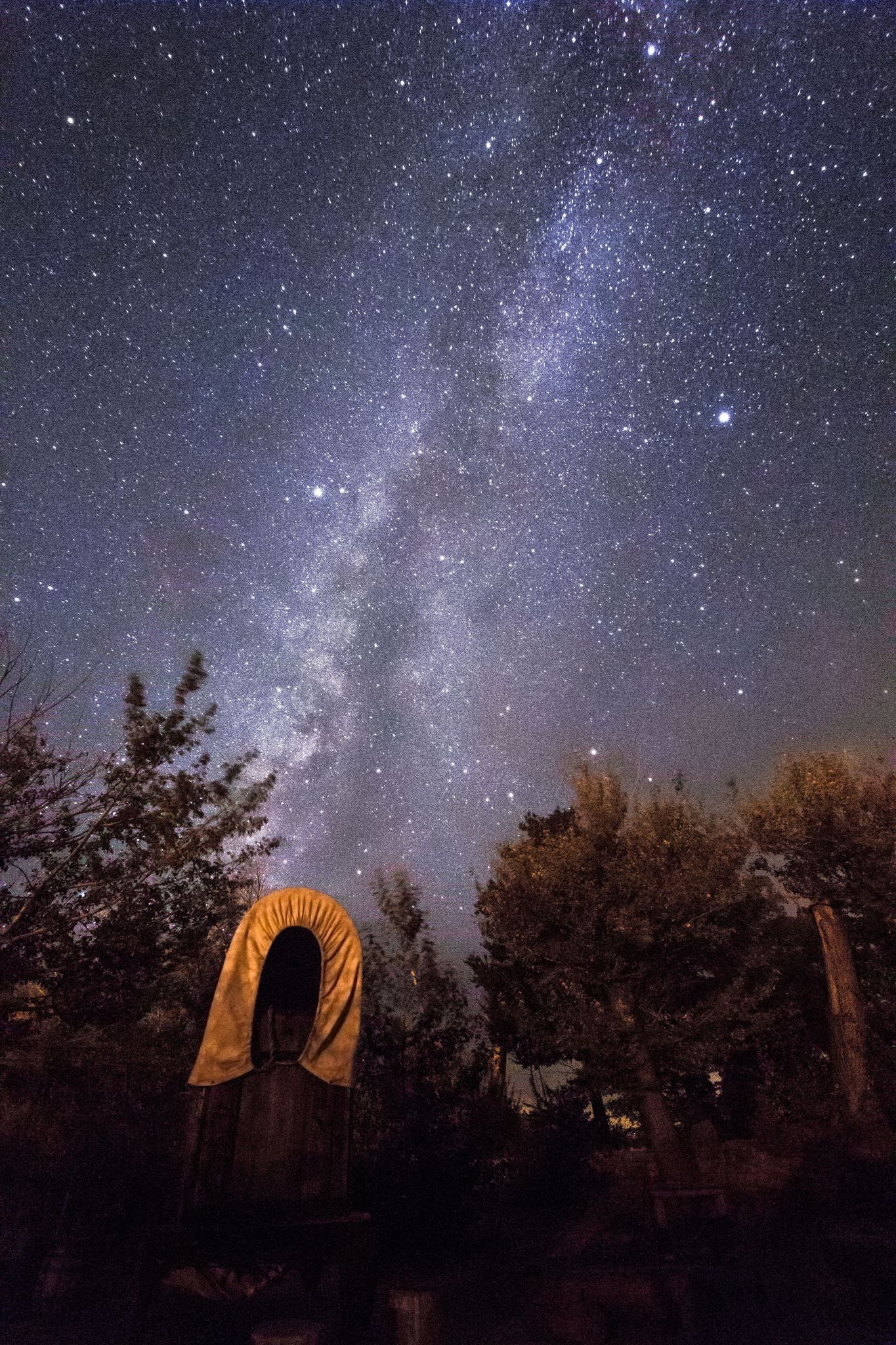 The Milky Way glitters above the chuckwagon at Pipe Spring National Monument. The monument has great night sky clarity because it is located inside the first Dark Sky Nation: The Kaibab Indian Reservation.