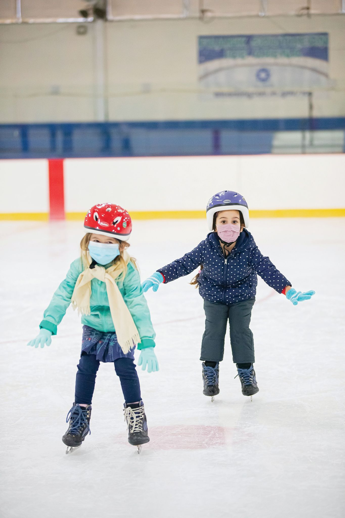 Two Young Children During Group Skating Lessons