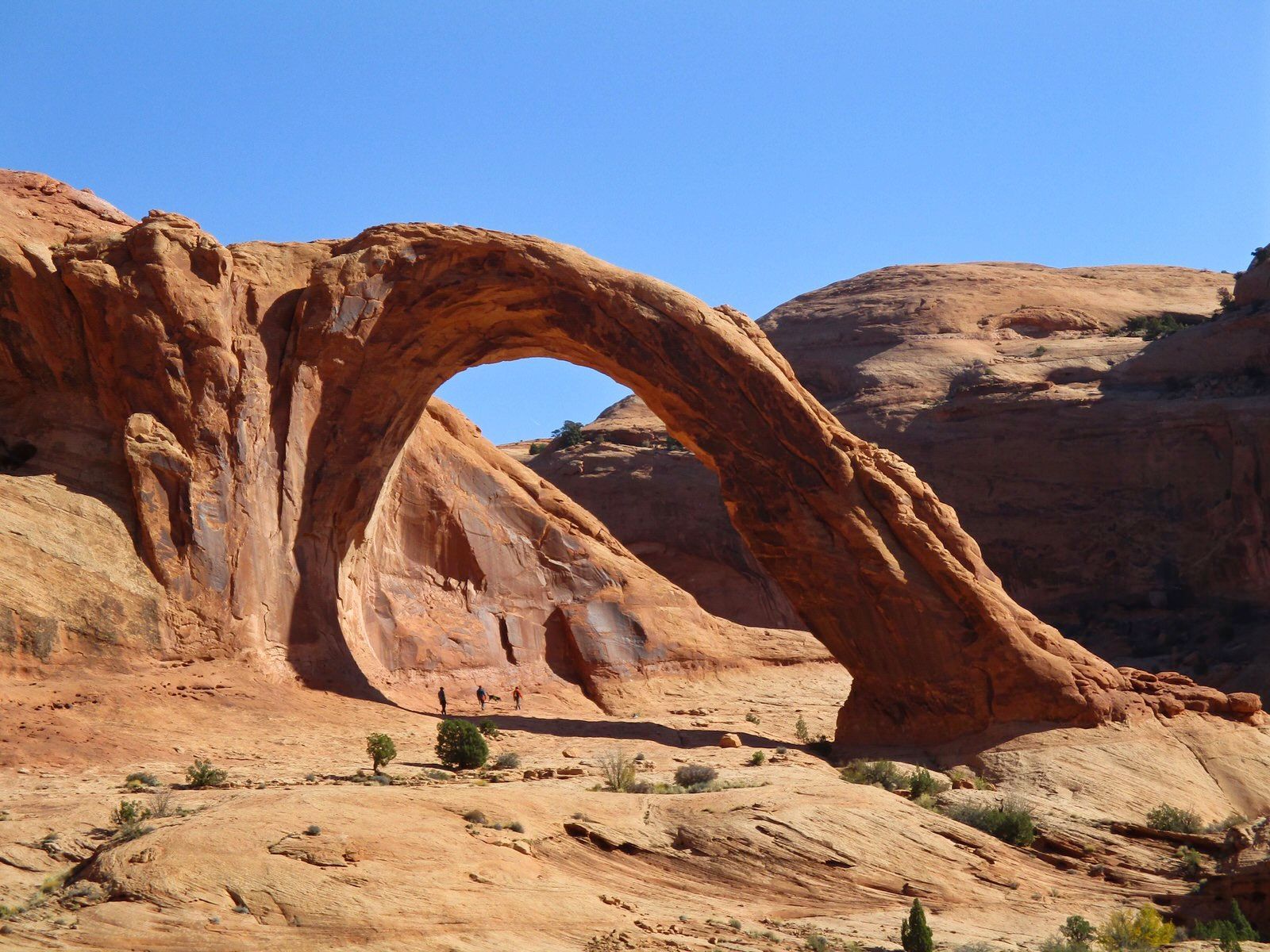 Hikers beneath Corona Arch. Photo by Valerie A. Russo.