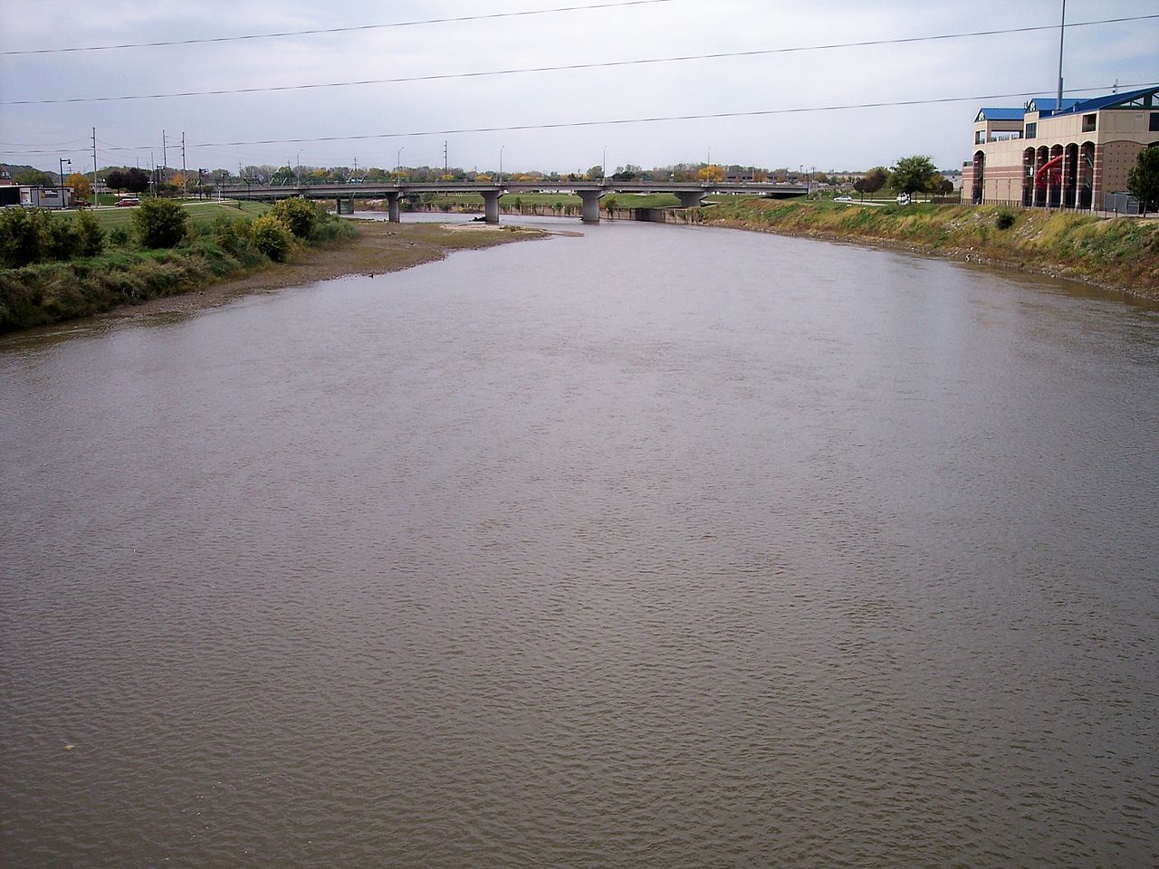 The Raccoon River inDes Moines, Iowa, as viewed upstream from a pedestrian bridge at its mouth at the Des Moines River. Photo by Tim Kiser.