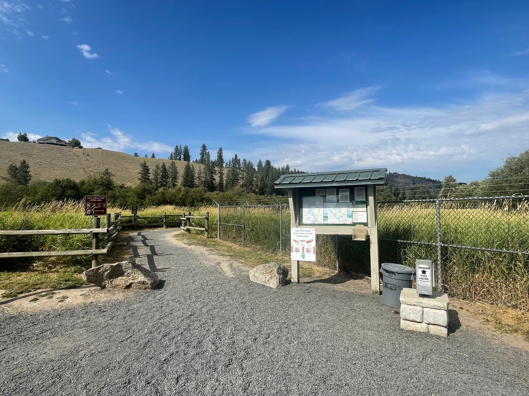 View of St. George put-in parking lot kiosk and trail to the Little Spokane river.