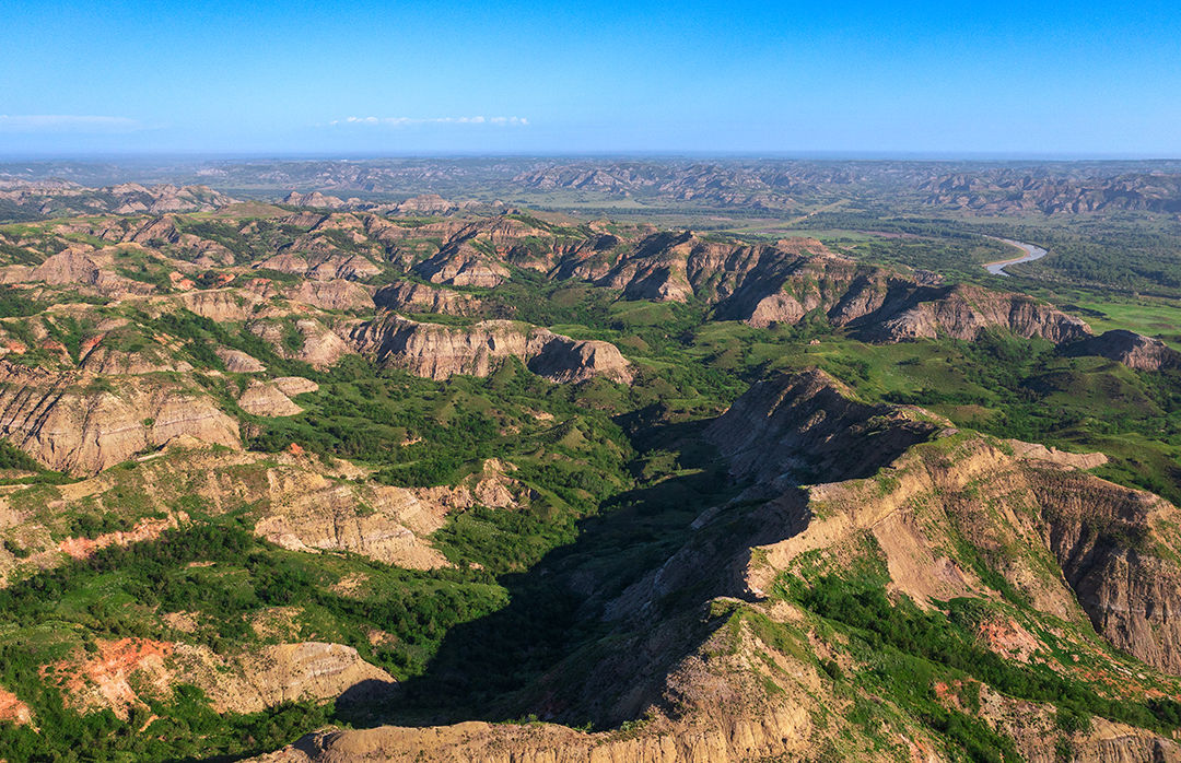 An oblique photo shot from a drone of Little Missouri State Park's badlands terrain.
