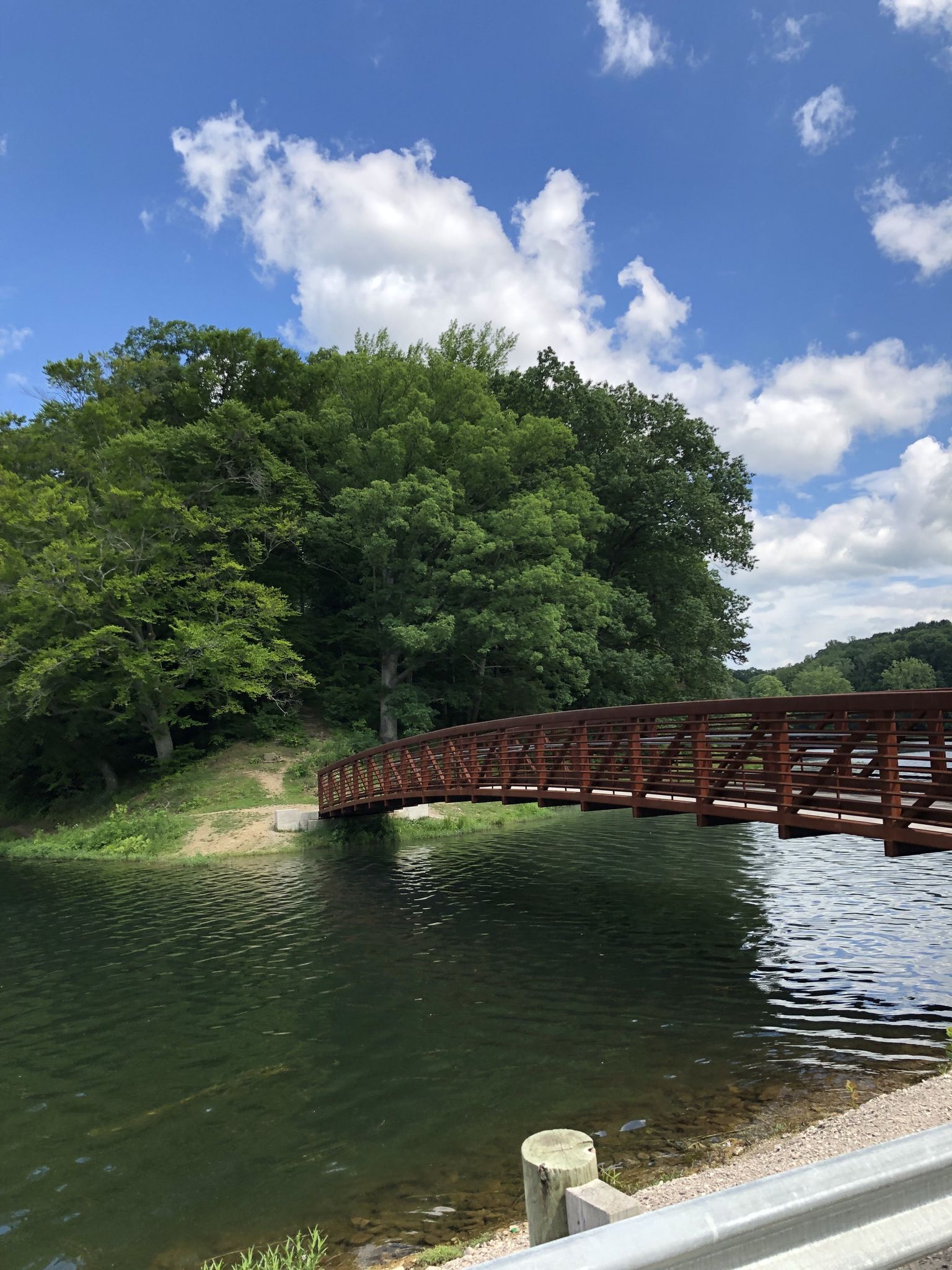 a view of the bridge at lake alma state park over the water with blue skies