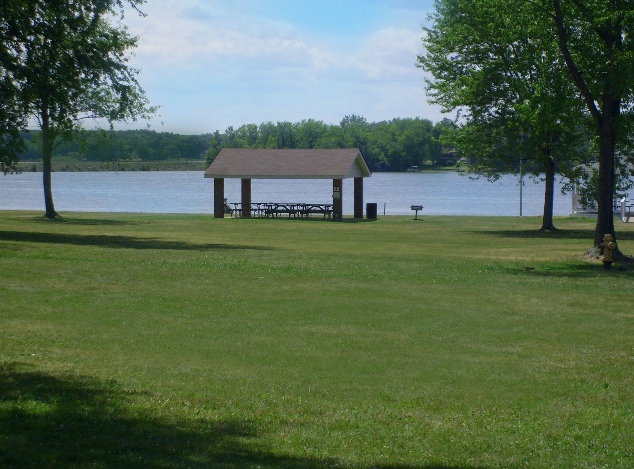 shelter pavilion sitting by lake white on a sunny day