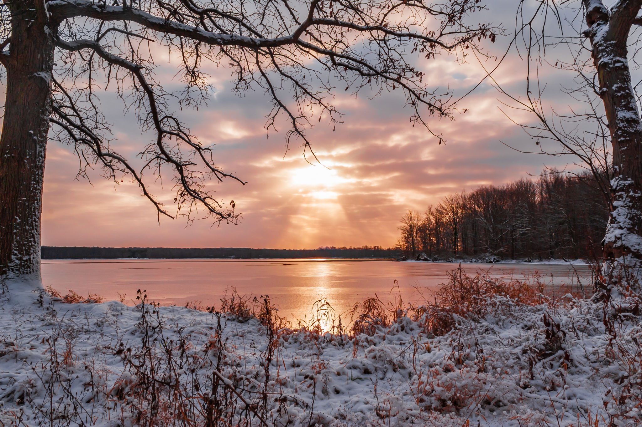 mosquito lake on a winter morning with orange clouds and sun reflecting off the water