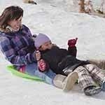 Mom and Child Sledding at Hidden Valley