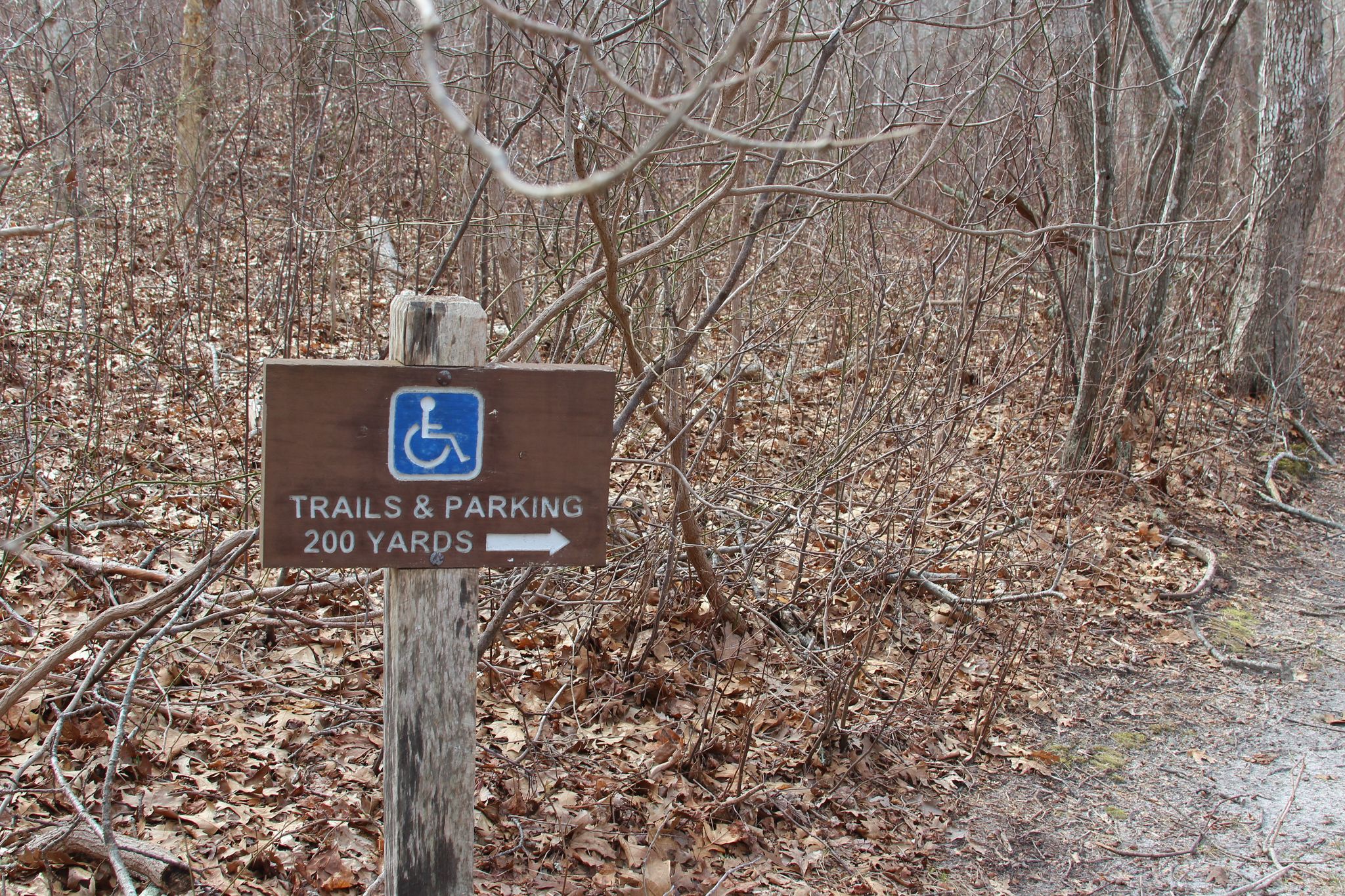 sign leading to accessible parking area