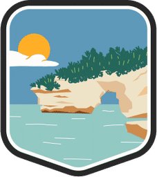 An illustrated badge for the Michigan community showing a lakeside rock formation with scrub on top and a clear blue sky.