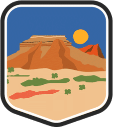 An illustrated badge for the Oklahoma community featuring a flat desert prairie landscape with a butte and a setting sun in the background.