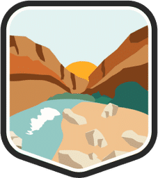 An illustrated badge for the Texas community showing a desert canyon with rocky cliffs and a river flowing through it under a clear blue sky.