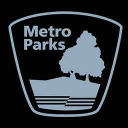 Metro Parks logo in grey with black background